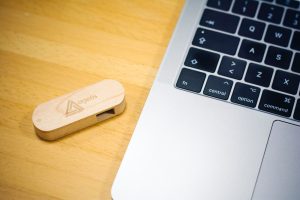 brown thumb drive beside MacBook